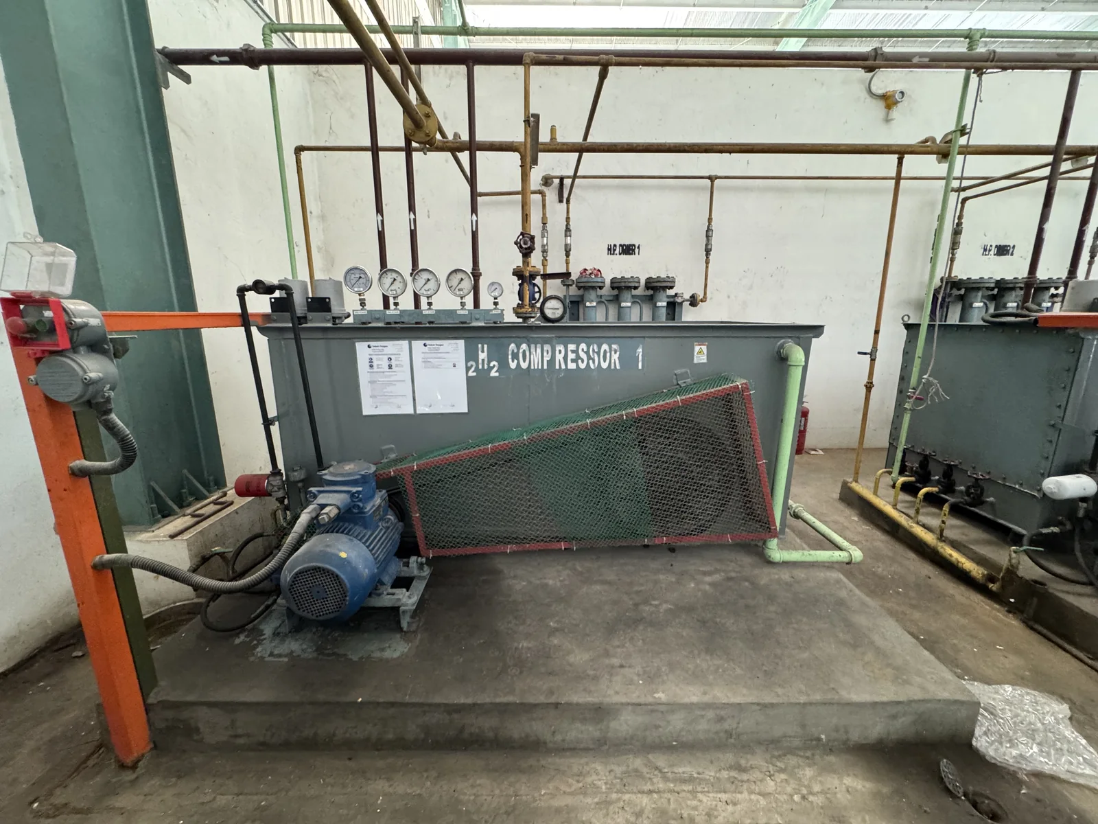 Industrial reciprocating compressor and associated pipework in a gas plant compressor room