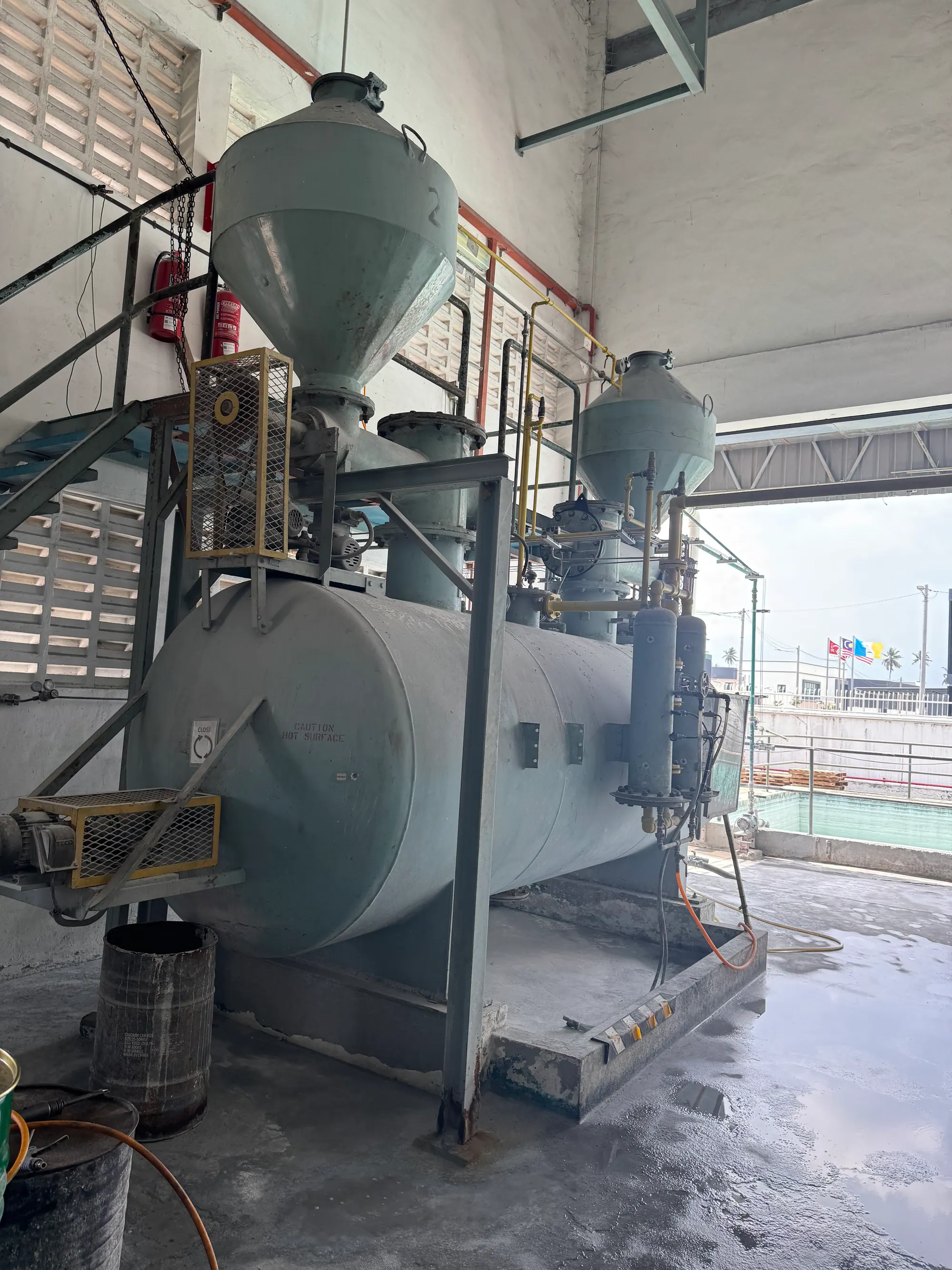 Acetylene plant pressure vessels and compressor connected by painted process pipework