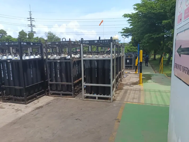 Carbon dioxide cylinders stored upright in pallet racking at a gas distribution works