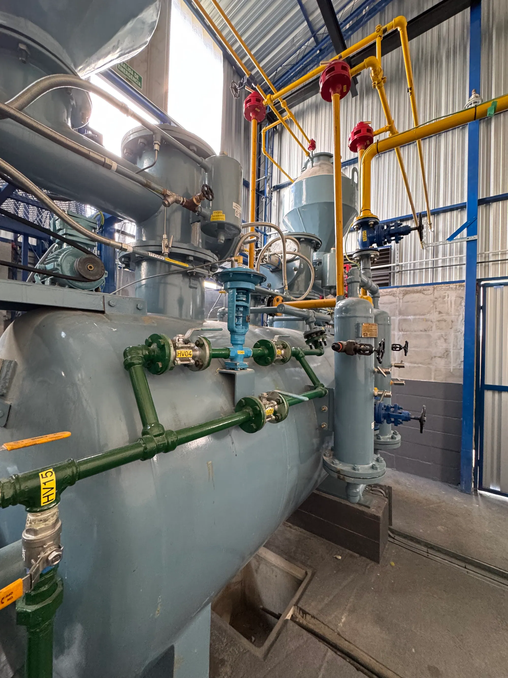 Gas plant process pipework with colour-coded valves, gauges and a vessel manifold