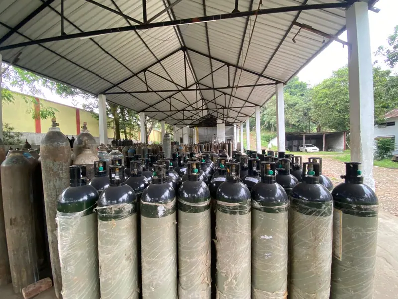 Industrial gas cylinder yard with cylinders stored upright in secured rows